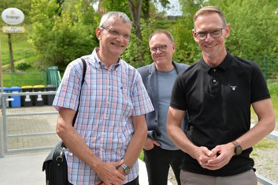 Uwe Donner (l.) vom Landratsamt, Bodo Stümpges von der Gemeindeverwaltung und Bürgermeister Dirk Müller (r.) vor der Sporthalle Niedersaida.