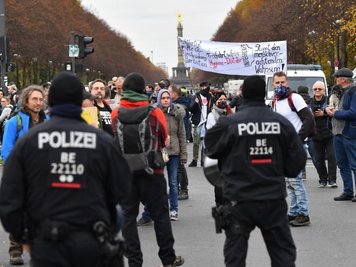             Teilnehmer einer Demonstration gegen die Corona-Einschränkungen der Bundesregierung potestieren nahe dem Brandenburger Tor.