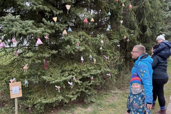 10.000 Eier sind das Ziel: Auf dem Lichtenauer Wanderweg ist wieder das Osterfieber ausgebrochen - René und Julia Roder aus Auerswalde schauen sich mit ihren Kindern Eleni (5) und Emi (2) einen liebevoll geschmückten Osterbaum an.