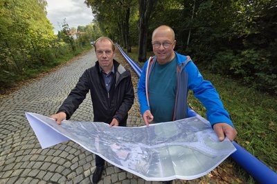 Planer Matthias Kreul von Ökoplan Plauen (links) und Falk Schmidt, Bauleiter des Zwav, mit dem Plan zur Neutrassierung der Fernwasserleitung von Adorf nach Bad Brambach.