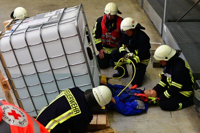 Bei der Übung wurde ein Staplerunfall mit einer verletzten Person simuliert. Der Verunglückte wurde mithilfe eines Schwerlasthebekissens unter einem Antischaummittelbehälter geborgen. 