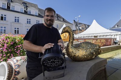Lichttechniker René Schmidt gehört zu den Spezialisten, die auf dem Annaberger Markt das Veranstaltungsgelände perfekt in Szene setzen. Auch der Brunnen erhält Scheinwerfer.