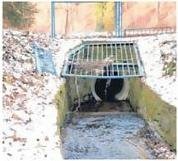 Das entfernte Gitter liegt neben dem Schachteinlauf des Gansbaches im Freibadgelände.