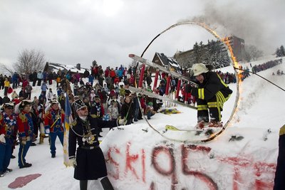 Eric Scheunert von der Oberwiesenthaler Feuerwehr beteilgt sich mit einem waghalsigen Sprung durch einen brennenden Reifen am traditionellen Narrenspringen.