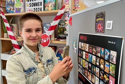 Schüler-Reporterin Frida Schellenberg testet das "sprechende Bücherregal" des Buchsommers 2024 in Schwarzenberg.