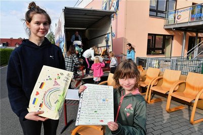 Die siebenjährige Mariella zeigt den Brief der Hortkinder aus Halsbrücke an ihre Altersgefährten in Oskil, den Arina Tyvonenko übersetzt hat. 