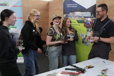 Oliver Schenk (rechts), Ausbildungsleiter bei der Firma Purkart aus Niederschmiedeberg, zeigt Jugendlichen von der Oberschule Jöhstadt, wie sie ihre eigenen Minecraft-Figuren zusammenbauen.