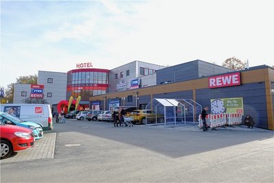 Das Einkaufszentrum Am Annenplatz hat im Erdgeschoss und im 1. Stock einen Anbau erhalten, siehe dunkelgraue Segmente. Rewe und Jysk vergrößern ihre Filialen. Dafür musste der untere Parkplatz neu gestaltet werden.