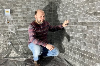 Andreas Ronneberger,  Chef des Kinos in Mittweida, schaut sich die Fliesen in der neuen Herrentoilette an. Die wird im ersten Stock eingerichtet.