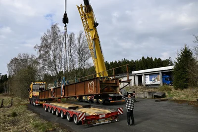 Die alte Bahnbrücke wurde vom Tieflader gehoben und auf der Ladestraße des Bahnhofs Hammerbrücke abgelegt.
