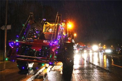 Geschmückt mit bunten Lichterketten reihen sich vom Traktor bis zum Truck eine ganze Reihe von Fahrzeugen auf.