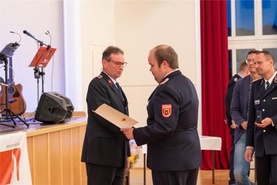 Simon Glowa, Regionalbereichsleiter Stollberg (M.), bei der festlichen Veranstaltung in der Stadthalle Oelsnitz.
