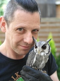 Rainer Sonneborn hat die junge Weißgesichtseule Herr Fussel auf der Hand.