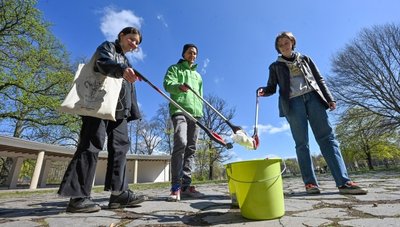 Nina Schober, Kenny Ott, und Dora Kiesewalter (von links) von Greenpeace Chemnitz beim Aufräumen auf der Schloßteichinsel.