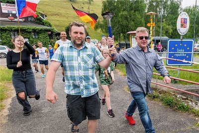 Thomas Seitz und Lukáš Pakosta (v. r.), überquerten mit der Fackel gemeinsam die Grenze.