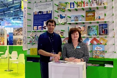 Sachsendruck-Geschäftsführer Ralf Fischer und Kundenberaterin Katrin Tödtmann am Gemeinschaftsstand Sachsen in Frankfurt.
