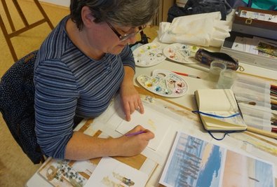 Konzentriert arbeitet Kathrin Werner an ihrem Aquarell. Das Thema sind Spiegelungen.