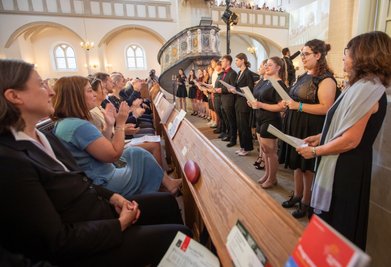Der Kammerchor des Lessing-Gymnasiums unter Leitung von Kathrin Büchold (rechts) sang in der Johanniskirche die von "Freie Presse"-Lesern neu getextete Plauen-Hymne. Die Honoratioren in der ersten Reihe waren begeistert.