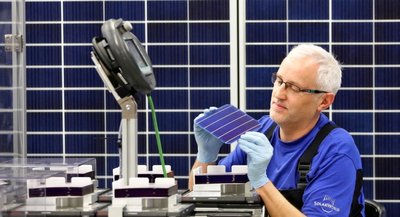 Ein Solarworld-Mitarbeiter der Modulfertigung prüft eine Solarzelle. Die Zellen werden in den Solarmodulen verbaut. Künftig soll die Produktion der Zellen in Arnstadt konzentriert werden.