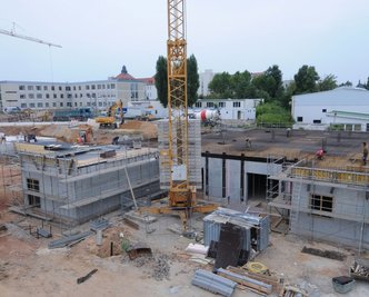 Der Rohbau nimmt Gestalt an. Fertig gestellt wurde bisher die erste Ebene. Momentan wird die Schalung für die zweite Ebene vorbereitet.