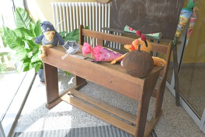Im Foyer der Grundschule steht eine historische Schulbank.