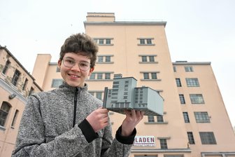 3D-Modell von historischer Hochgarage: Ein 16-jähriger Chemnitzer und der Drucker im Gäste-Klo - Schüler Ruben Bartsch mit seinem selbst entworfenen Tastmodell aus dem 3D-Drucker. Im Hintergrund das Original: Die historische Hochgarage des Chemnitzer Fahrzeugmuseums.