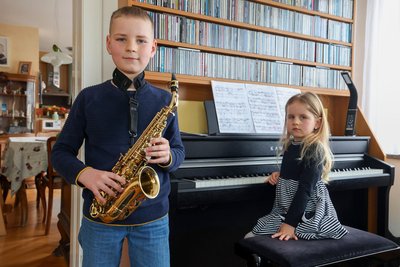 Die fünfjährige Eva Engel mit ihrem Bruder Kai, der neben Klavier auch noch Saxofon lernt.