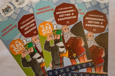 Stadtgründer Herzog Heinrich und ein Bergmann werben auf einem ersten Flyer für den Bergmannstag und den Unesco-Welterbetag im kommenden Jahr in Marienberg.