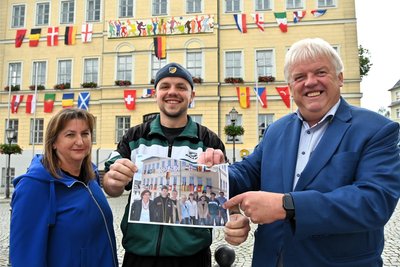 Juni 2024: Birgit Reichert, Mladen Ceko und OB Dieter Greysinger präsentierten das mit Flaggen gestalteten Rathaus in Hainichen. Der heute 33-jährige Mladen Ceko war schon 2006 dabei, als das Rathaus erstmals zum Fußball-Tempel wurde.