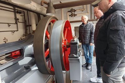 Jürgen Löschner (im Hintergrund) erklärte die Funktionsweise der Dampfmaschine.