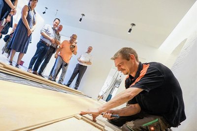 Soviel Aufmerksamkeit hat Parkettleger Marcel Scheidewind vermutlich nicht immer bei der Arbeit. Hier demonstriert er, wie Fugen mittels Verkeilen „verschwinden“.