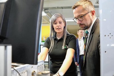 SKS-Vorarbeiterin Alexandra Müller zeigt Sachsens Wirtschaftsminister Martin Dulig einen Kabelverteiler.