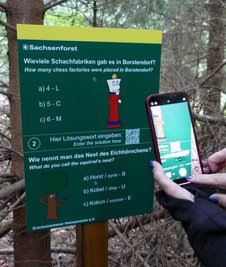 Auf zehn Tafeln warten Quizfragen, die per QR-Code digital lösbar sind.