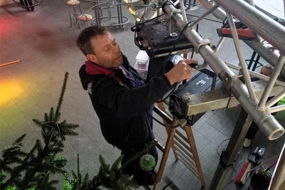 Robby Fischer montiert in der Bahnhofshalle Flöha einen Scheinwerfer