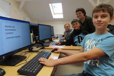 Rafael, Sinuhe und Alexa recherchieren gemeinsam mit Angela Kießling am PC für neue Texte.