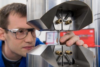 Ralf Eckner, wissenschaftlicher Mitarbeiter am Institut für Werkstofftechnik, testet den neuen Werkstoff auf Zugfestigkeit. 