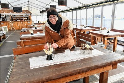 Das Winterzelt der Eisbahn im Schlosshof Freudenstein Freiberg bietet 80 Sitzplätze. Im Bild Tina Meier, Mitarbeiterin im Schloßcafé, beim Eindecken. 
