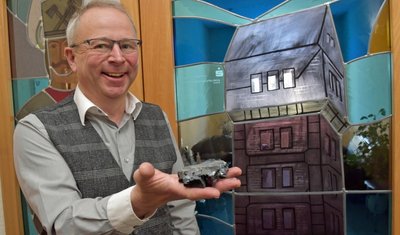 Bürgermeister Bernd Birkigt hat gut Lachen, Millionen Tonnen Steinkohle sind rund um Oelsnitz abgebaut worden. Auf seinem Dienstschreibtisch findet sich stellvertretend ein Exemplar des Naturprodukts. 