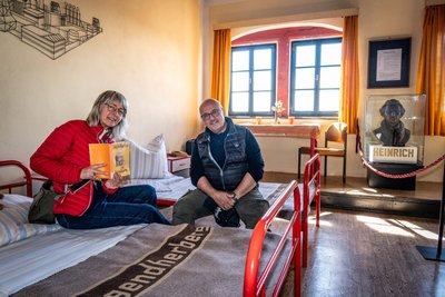 Gaby und Andres Bilz durften fürs Foto ausnahmsweise auf den originalen Betten im Jugendherbergszimmer der Dauerausstellung Platz nehmen.