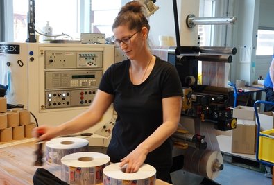 Kathrin Harms an der Rotoflexmaschine macht die Etiketten für die Versendung fertig. 