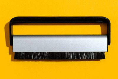 Kohlefaser-Bürste zum Auskehren einer Schallplatte: Die Borsten sind nur etwa ein Zehntel so stark wie ein Menschenhaar und kommen daher im Gegensatz zu herkömmlichen Stofffasern wirklich in die Vinyl-Mikrorillen, wo Hausstaub-Partikel auf die empfindliche Nadel die Wirkung von mikroskopischem Geröll haben. 