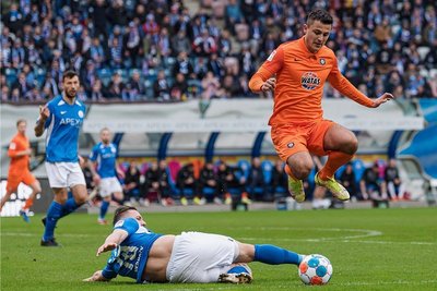 Antonio Jonjic, Schütze zum entscheidenden 2:1, springt über John Verhoek. Der FC Erzgebirge überspringt damit die Hürde Hansa Rostock.