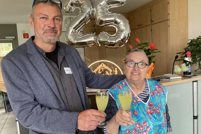 Von Anfang an dabei: Zweigstellenleiter Rainer Pilz und Arbeiterin Christine Hahn stoßen auf das Werkstatt-Jubiläum an.