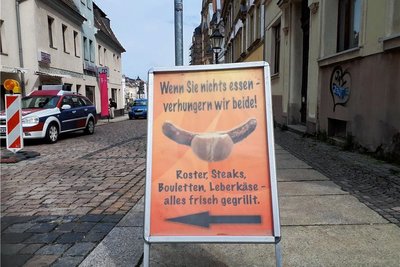 Mit diesem Aufsteller wirbt der "Rostermaa" für sein Gegrilltes. 
