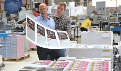 Geschäftsführer Torsten Zech (l.) und sein Sohn Maximilian Zech kontrollieren an einer Stapelmaschine die Ausdrucke.