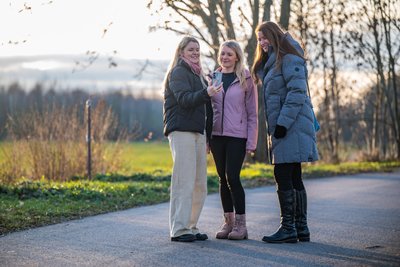 Blick in die Natur – und aufs Telefon: Beim Krimiwandern folgt man Hinweisen über einen QR-Code. Gina Schultz, Mandy Fleischer und Susann Weist (von links) haben sich das ausgedacht.