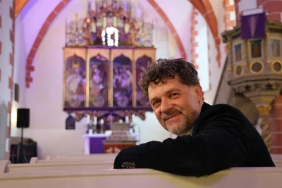 Pfarrer Falk Klemm in seiner Kirche. Im Hintergrund sieht man den besonderen Altar.