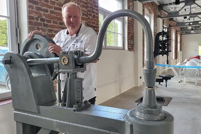 Ein Stück Geschichte: Jens Trübenbach mit einer der Maschinen, die er restauriert und der Stadt überlassen hat.