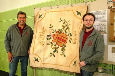 Thomas Pollrich (li) und Markus Stark präsentieren die 131 Jahre alte Vereinsfahne.