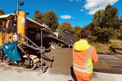 Der Schichtleiter überwacht die Arbeiten. Beton hält den Belastungen des Verkehrs besser Stand als Asphalt.